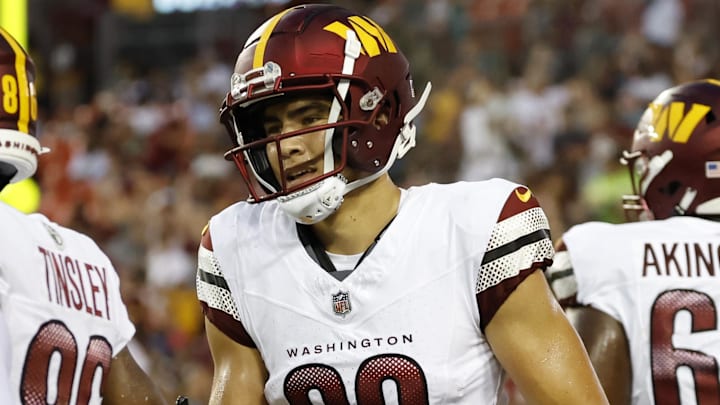 Aug 26, 2023; Landover, Maryland, USA; Washington Commanders wide receiver Brycen Tremayne (89) celebrates with teammates after scoring a touchdown against the Cincinnati Bengals during the third quarter at FedExField. Mandatory Credit: Geoff Burke-Imagn Images