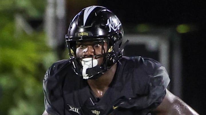 Sep 16, 2023; Orlando, Florida, USA; UCF Knights tight end Randy Pittman (13) carries the ball against Villanova Wildcats defensive back Isas Waxter (0) during the second half at FBC Mortgage Stadium. Mandatory Credit: Mike Watters-Imagn Images