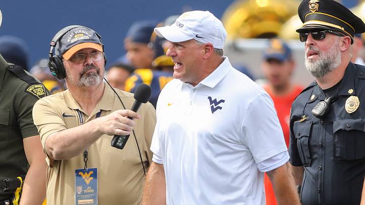 Sep 12, 2026; Morgantown, West Virginia, USA; West Virginia Mountaineers head coach Rich Rodriguez answers questions during an interview as he walks into halftime against the UT Martin Skyhawks at Milan Puskar Stadium. Mandatory Credit: Ben Queen-Imagn Images Sep 12, 2026; Morgantown, West Virginia, USA; West Virginia Mountaineers head coach Rich Rodriguez answers questions during an interview as he walks into halftime against the UT Martin Skyhawks at Milan Puskar Stadium. Mandatory Credit: Ben Queen-Imagn Images