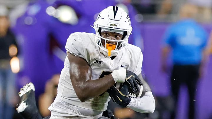 Sep 14, 2024; Fort Worth, Texas, USA; TCU Horned Frogs defensive lineman Caleb Fox (90) attempts a tackle on UCF Knights tight end Randy Pittman Jr. (5) during the fourth quarter at Amon G. Carter Stadium. Mandatory Credit: Andrew Dieb-Imagn Images