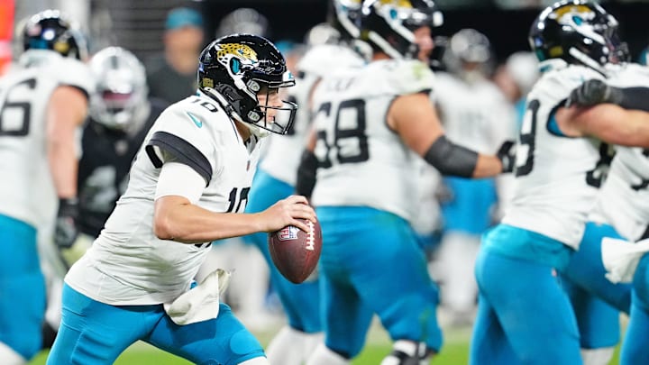 Dec 22, 2024; Paradise, Nevada, USA; Jacksonville Jaguars quarterback Mac Jones (10) gains yardage against the Las Vegas Raiders during the fourth quarter at Allegiant Stadium. Mandatory Credit: Stephen R. Sylvanie-Imagn Images