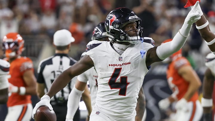 Sep 15, 2024; Houston, Texas, USA; Houston Texans cornerback Kamari Lassiter (4) celebrates his interception against the Chicago Bears in the second half at NRG Stadium. Mandatory Credit: Thomas Shea-Imagn Images