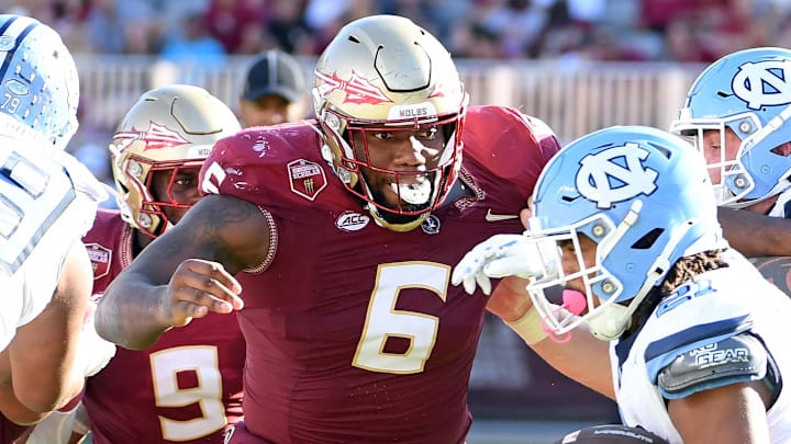 Nov 2, 2024; Tallahassee, Florida, USA;  Florida State Seminoles defensive tackle Darrell Jackson Jr (6) pursues North Carolina Tarheels running back Davion Gause (21) in the second quarter at Doak S. Campbell Stadium. Mandatory Credit: Robert Myers-Imagn Images