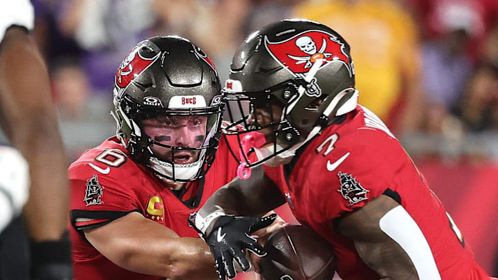 Oct 21, 2024; Tampa, Florida, USA; Tampa Bay Buccaneers quarterback Baker Mayfield (6) hands the ball off to running back Bucky Irving (7) against the Baltimore Ravens during the first quarter at Raymond James Stadium. Mandatory Credit: Kim Klement Neitzel-Imagn Images