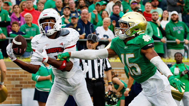 Louisville wide receiver Ja'Corey Brooks (1) catches a pass in the end zone for a touchdown with Notre Dame cornerback Leonard Moore (15) defending during a NCAA college football game between Notre Dame and Louisville at Notre Dame Stadium on Saturday, Sept. 28, 2024, in South Bend.