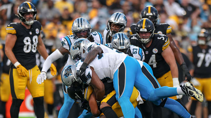 Aug 21, 2025; Charlotte, North Carolina, USA; Pittsburgh Steelers running back Jaylen Warren (30) is tackled by Carolina Panthers defensive tackle Shy Tuttle (99) and outside linebacker Boogie Basham (54) during the first quarter at Bank of America Stadium. Mandatory Credit: Allison Lawhon-Imagn Images Aug 21, 2025; Charlotte, North Carolina, USA; Pittsburgh Steelers running back Jaylen Warren (30) is tackled by Carolina Panthers defensive tackle Shy Tuttle (99) and outside linebacker Boogie Basham (54) during the first quarter at Bank of America Stadium. Mandatory Credit: Allison Lawhon-Imagn Images