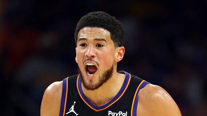 Phoenix, Arizona, USA; Phoenix Suns guard Devin Booker (1) reacts against the Golden State Warriors during the first half in the play-in rounds of the 2026 NBA Playoffs at Mortgage Matchup Center on Apr 17, 2026.