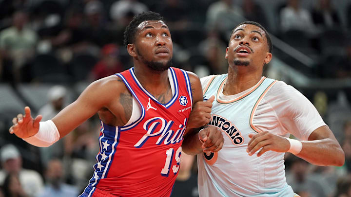 Mar 21, 2025; San Antonio, Texas, USA; Philadelphia 76ers forward Justin Edwards (19) blocks San Antonio Spurs forward Keldon Johnson (0) during the second quarter at Frost Bank Center.