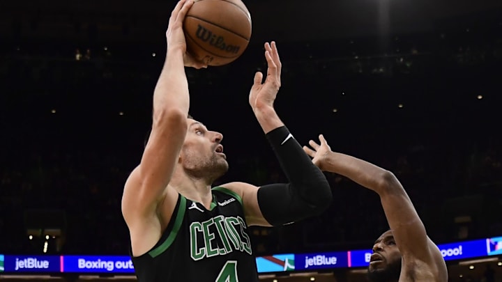 Feb 6, 2026; Boston, Massachusetts, USA; Miami Heat forward Andrew Wiggins (22) defends Boston Celtics center Nikola Vucevic (4) during the second half at TD Garden. Mandatory Credit: Bob DeChiara-Imagn Images