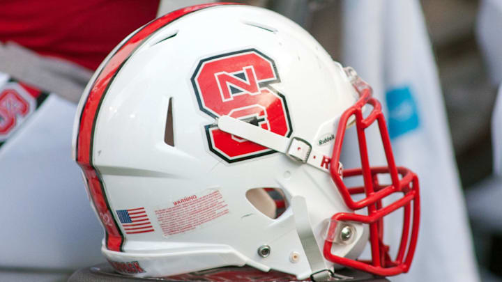 Sep 5, 2015; Raleigh, NC, USA; A North Carolina State Wolfpack helmet lays on the field during the first half against the Troy Trojans at Carter Finley Stadium. North Carolina State defeated Troy 49-21. Mandatory Credit: Jeremy Brevard-Imagn Images