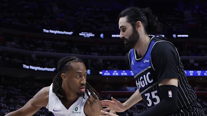 Detroit Pistons guard Daniss Jenkins dribbles defended by Orlando Magic center Goga Bitadze.