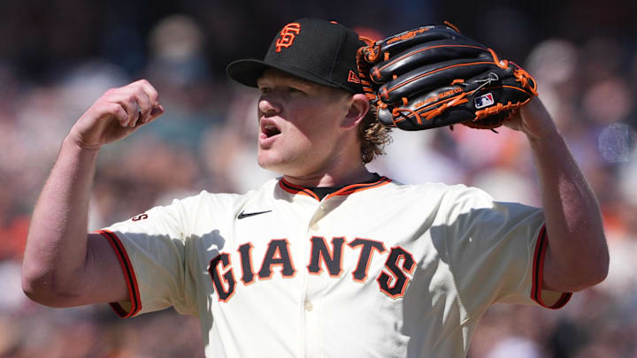 Apr 7, 2024; San Francisco, California, USA; San Francisco Giants starting pitcher Logan Webb (62) reacts after a safe call at first base during the seventh inning against the San Diego Padres at Oracle Park. Apr 7, 2024; San Francisco, California, USA; San Francisco Giants starting pitcher Logan Webb (62) reacts after a safe call at first base during the seventh inning against the San Diego Padres at Oracle Park.