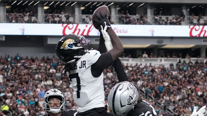 Nov 2, 2025; Paradise, Nevada, USA; Jacksonville Jaguars wide receiver Brian Thomas Jr. (7) attempts to catch the ball against Las Vegas Raiders safety Isaiah Pola-Mao (20) and cornerback Darien Porter (26) in the first half at Allegiant Stadium. Mandatory Credit: Kirby Lee-Imagn Images Nov 2, 2025; Paradise, Nevada, USA; Jacksonville Jaguars wide receiver Brian Thomas Jr. (7) attempts to catch the ball against Las Vegas Raiders safety Isaiah Pola-Mao (20) and cornerback Darien Porter (26) in the first half at Allegiant Stadium. Mandatory Credit: Kirby Lee-Imagn Images