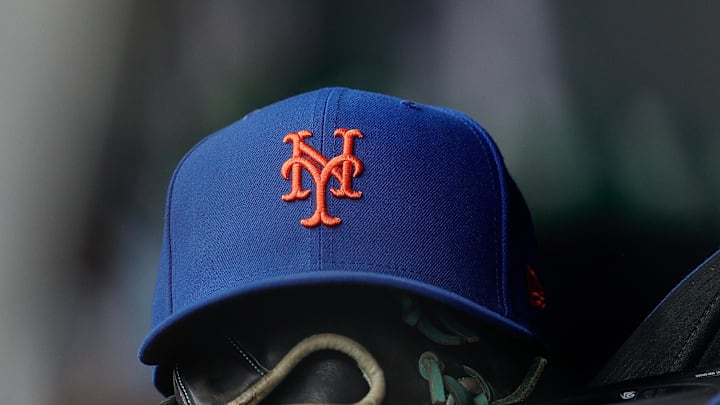 New York Mets hat and glove in the dugout in the second inning against the Colorado Rockies at Coors Field in 2024. 