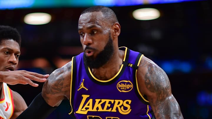 Jan 3, 2025; Los Angeles, California, USA; Los Angeles Lakers forward LeBron James (23) moves the ball against Atlanta Hawks forward De'Andre Hunter (12) during the second half at Crypto.com Arena. Mandatory Credit: Gary A. Vasquez-Imagn Images
