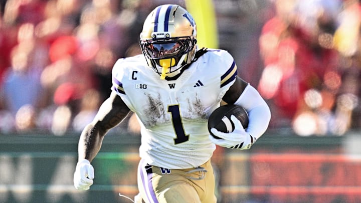 Washington Huskies running back Jonah Coleman carries the ball against the Maryland Terrapins at SECU Stadium.