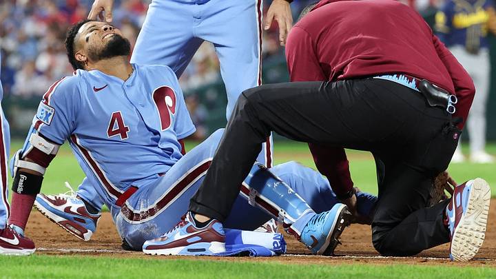 Sep 24, 2026; Philadelphia, Pennsylvania, USA; Philadelphia Phillies second baseman Luis Arraez (4) is checked on by trainer Christian Bermudez and first base coach Paco Figueroa (38) after being injured on a play against the Milwaukee Brewers during the sixth inning at Citizens Bank Park. Mandatory Credit: Bill Streicher-Imagn Images