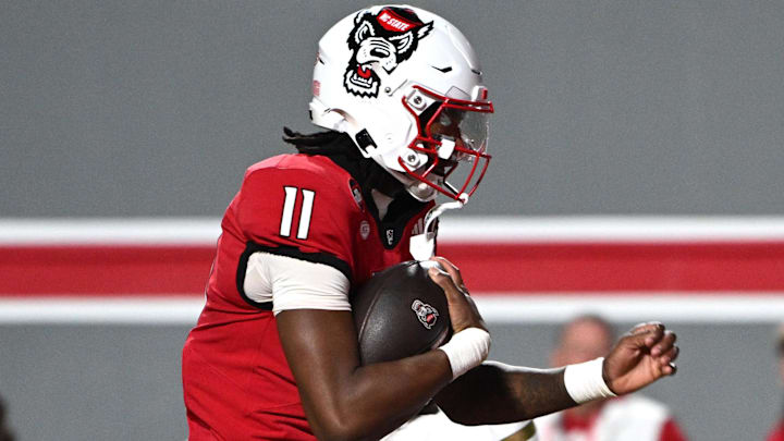 Nov 1, 2025; Raleigh, North Carolina, USA;  North Carolina State Wolfpack quarterback CJ Bailey (11) scores a touchdown against the Georgia Tech Yellow Jackets during the first quarter at Carter-Finley Stadium. Mandatory Credit: Zachary Taft-Imagn Images