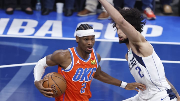 Dec 10, 2024; Oklahoma City, Oklahoma, USA; Oklahoma City Thunder guard Shai Gilgeous-Alexander (2) drives to the basket beside Dallas Mavericks center Dereck Lively II (2) during the first quarter at Paycom Center. Mandatory Credit: Alonzo Adams-Imagn Images