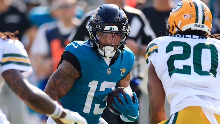 Jacksonville Jaguars wide receiver Christian Kirk (13) rushes for yards against Green Bay Packers safety Xavier McKinney (29) and safety Javon Bullard (20) during the third quarter of an NFL football matchup Sunday, Oct. 27, 2024 at EverBank Stadium in Jacksonville, Fla. The Packers edged the Jaguars 30-27 on a last-second field goal. [Corey Perrine/Florida Times-Union]