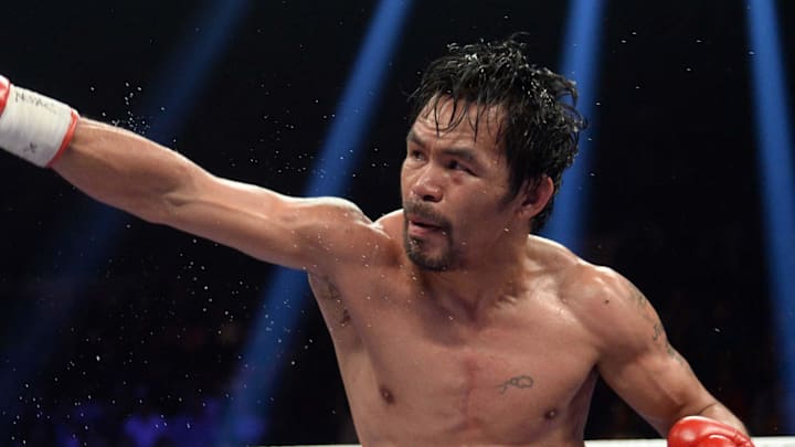 Jan 19, 2019; Las Vegas, NV, USA; Manny Pacquiao (black trunks) and Adrien Broner (purple/gold trunks) box during a WBA welterweight world title boxing match at MGM Grand Garden Arena. Pacquiao won via unanimous decision. Mandatory Credit: Joe Camporeale-Imagn Images Jan 19, 2019; Las Vegas, NV, USA; Manny Pacquiao (black trunks) and Adrien Broner (purple/gold trunks) box during a WBA welterweight world title boxing match at MGM Grand Garden Arena. Pacquiao won via unanimous decision. Mandatory Credit: Joe Camporeale-Imagn Images