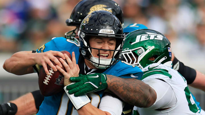 Jacksonville Jaguars quarterback Mac Jones (10) steps up in the pocket to run as pressured by New York Jets defensive tackle Quinnen Williams (95) during the second quarter Sunday, Dec. 15, 2024 at EverBank Stadium in Jacksonville, Fla. 