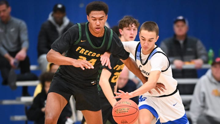 Freedom forward Donovan Davis (24) and Brookfield Central guard Ethan Koceja (5) chase a loose ball in the Rick Majerus WBY Shootout on Saturday, December 27, 2025, at Concordia University in Mequon, Wisconsin. Freedom won, 74-58.
