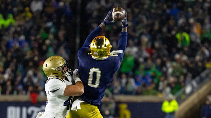 Nov 8, 2025; South Bend, Indiana, USA; Notre Dame Fighting Irish wide receiver Malachi Fields (0) makes a catch as Navy Midshipmen linebacker Adam Klenk (49) defends during the first half at Notre Dame Stadium. Mandatory Credit: Michael Caterina-Imagn Images Nov 8, 2025; South Bend, Indiana, USA; Notre Dame Fighting Irish wide receiver Malachi Fields (0) makes a catch as Navy Midshipmen linebacker Adam Klenk (49) defends during the first half at Notre Dame Stadium. Mandatory Credit: Michael Caterina-Imagn Images