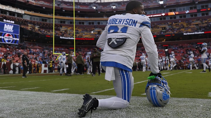 Nov 9, 2025; Landover, Maryland, USA; Detroit Lions cornerback Amik Robertson (21) kneels on the field during warmups prior to a game against the Washington Commanders at Northwest Stadium. Nov 9, 2025; Landover, Maryland, USA; Detroit Lions cornerback Amik Robertson (21) kneels on the field during warmups prior to a game against the Washington Commanders at Northwest Stadium.