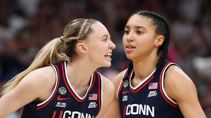 Apr 6, 2025; Tampa, FL, USA; Connecticut Huskies guard Paige Bueckers (5) reacts with teammates guard Ashlynn Shade (12) and guard Azzi Fudd (35) during the second half against the South Carolina Gamecocks of the national championship of the women's 2025 NCAA tournament at Amalie Arena. Mandatory Credit: Nathan Ray Seebeck-Imagn Images Apr 6, 2025; Tampa, FL, USA; Connecticut Huskies guard Paige Bueckers (5) reacts with teammates guard Ashlynn Shade (12) and guard Azzi Fudd (35) during the second half against the South Carolina Gamecocks of the national championship of the women's 2025 NCAA tournament at Amalie Arena. Mandatory Credit: Nathan Ray Seebeck-Imagn Images