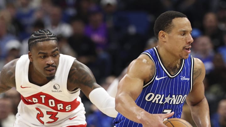 Orlando Magic guard Desmond Bane is guarded by Toronto Raptors guard Jamal Shead.