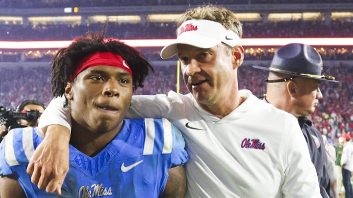 Mississippi Rebels head coach Lane Kiffin embraces running back Kewan Lacy (5)