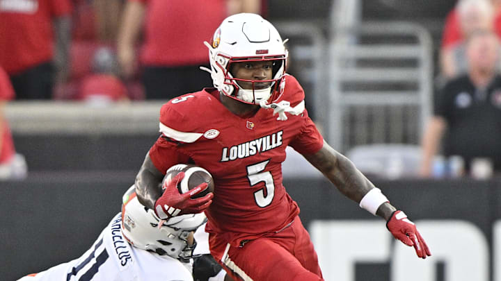 Oct 4, 2025; Louisville, Kentucky, USA; Louisville Cardinals wide receiver Caullin Lacy (5) runs the ball against Virginia Cavaliers linebacker Maddox Marcellus (11) during the second half at L&N Federal Credit Union Stadium. Virginia defeated Louisville 30-27. Mandatory Credit: Jamie Rhodes-Imagn Images Oct 4, 2025; Louisville, Kentucky, USA; Louisville Cardinals wide receiver Caullin Lacy (5) runs the ball against Virginia Cavaliers linebacker Maddox Marcellus (11) during the second half at L&N Federal Credit Union Stadium. Virginia defeated Louisville 30-27. Mandatory Credit: Jamie Rhodes-Imagn Images