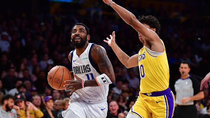 Nov 22, 2023; Los Angeles, California, USA; Dallas Mavericks guard Kyrie Irving (11) moves to the basket against Los Angeles Lakers guard Max Christie (10) during the first half at Crypto.com Arena. Mandatory Credit: Gary A. Vasquez-Imagn Images