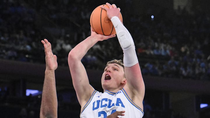 Dec 21, 2024; New York, NY, USA; UCLA Bruins forward Tyler Bilodeau (34) shoots the ball while being defended by North Carolina Tar Heels forward Ty Claude (0) during the first half at Madison Square Garden. Mandatory Credit: John Jones-Imagn Images