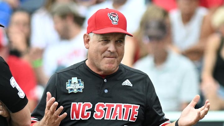 Jun 15, 2024; Omaha, NE, USA;  NC State Wolfpack head coach Elliott Avent discusses a balk call with an umpire in the game against the Kentucky Wildcats during the eighth inning at Charles Schwab Field Omaha. Mandatory Credit: Steven Branscombe-Imagn Images