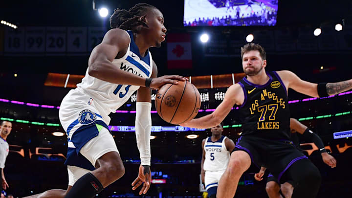 Mar 10, 2026; Los Angeles, California, USA; Minnesota Timberwolves guard Ayo Dosunmu (13) moves the ball against Los Angeles Lakers guard Luka Doncic (77) during the second half at Crypto.com Arena. Mar 10, 2026; Los Angeles, California, USA; Minnesota Timberwolves guard Ayo Dosunmu (13) moves the ball against Los Angeles Lakers guard Luka Doncic (77) during the second half at Crypto.com Arena.