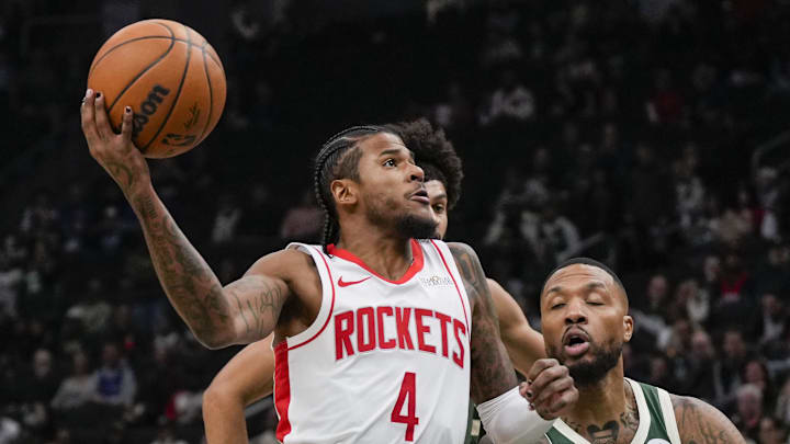 Nov 18, 2024; Milwaukee, Wisconsin, USA;  Houston Rockets guard Jalen Green (4) drives for the basket against Milwaukee Bucks guard Damian Lillard (0) during the first quarter at Fiserv Forum. Mandatory Credit: Jeff Hanisch-Imagn Images
