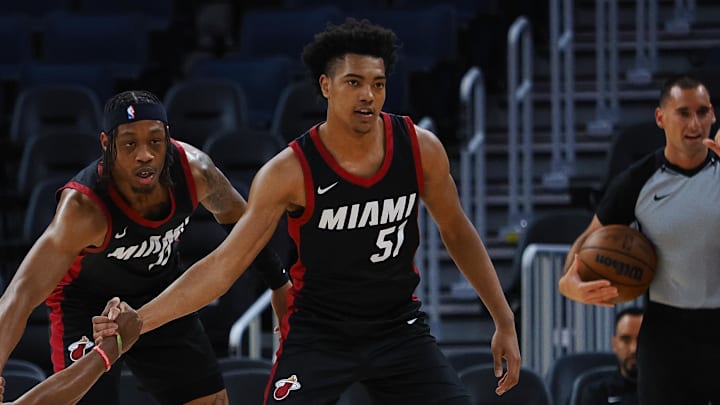 Jul 10, 2024; San Francisco, CA, USA; Los Angeles Lakers guard Bronny James Jr. (9) is helped up by Miami Heat guard Alondes Williams (15) and guard Bryson Warren (51) during the first quarter at Chase Center. Mandatory Credit: Kelley L Cox-Imagn Images