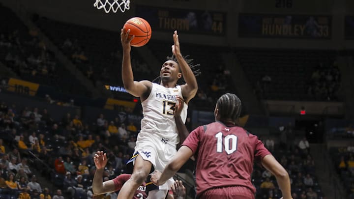 Dec 9, 2025; Morgantown, West Virginia, USA; West Virginia Mountaineers guard Chance Moore (13) shoots in the lane during the second half against the Little Rock Trojans at Hope Coliseum.
