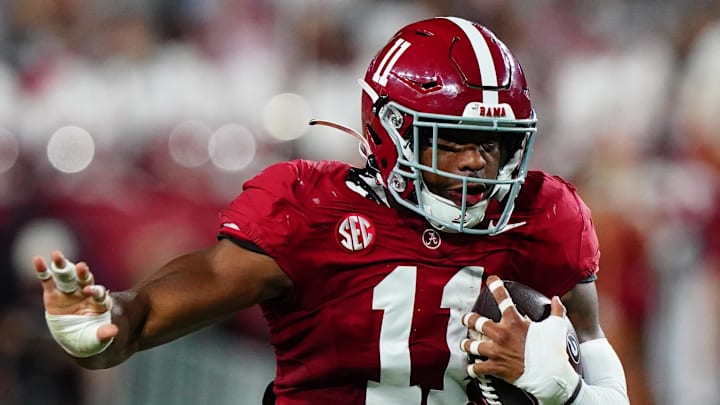 Alabama Crimson Tide linebacker Jihaad Campbell returns an interception against Georgia Bulldogs wide receiver Dillon Bell.
