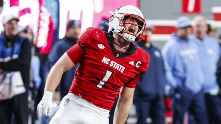 Nov 29, 2025; Raleigh, North Carolina, USA; NC State Wolfpack linebacker Caden Fordham (1) reacts to his tackle during the first half of the game against the North Carolina Tar Heels at Carter-Finley Stadium.  Mandatory Credit: Jaylynn Nash-Imagn Images