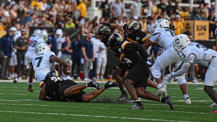 Southern Miss' defense sacks UConn quarterback Kalieb Osborne (7). Southern Miss' defense sacks UConn quarterback Kalieb Osborne (7).