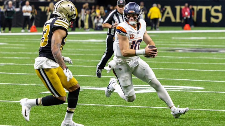 Oct 17, 2024; New Orleans, Louisiana, USA;  Denver Broncos quarterback Bo Nix (10) is tackled by New Orleans Saints cornerback Marshon Lattimore (23) during the first half at Caesars Superdome. 