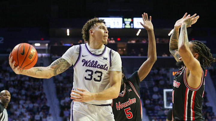 Jan 11, 2025; Manhattan, Kansas, USA; Kansas State Wildcats forward Coleman Hawkins (33) is guarded by Houston Cougars forward Ja’Vier Francis (5) and guard Emanuel Sharp (21) during the first half at Bramlage Coliseum. Mandatory Credit: Scott Sewell-Imagn Images