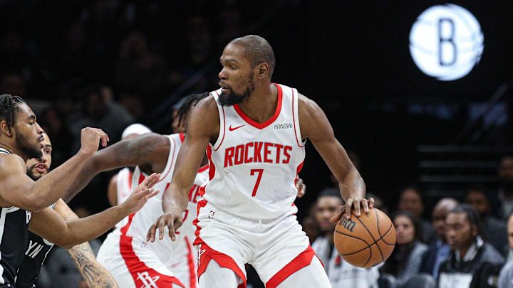 Jan 1, 2026; Brooklyn, New York, USA; Houston Rockets forward Kevin Durant (7) is guarded by Brooklyn Nets guard Cam Thomas (24) during the first half at Barclays Center. Mandatory Credit: Vincent Carchietta-Imagn Images