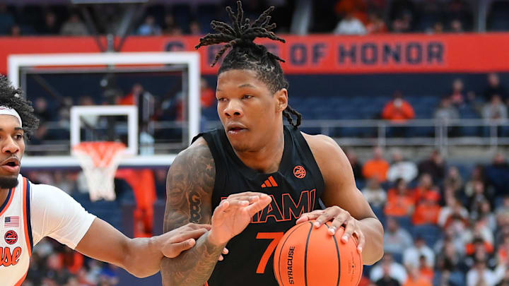 Jan 24, 2026; Syracuse, New York, USA; Miami Hurricanes forward Shelton Henderson (7) drives against Syracuse Orange guard J.J. Starling (2) during the first half at the JMA Wireless Dome. Mandatory Credit: Rich Barnes-Imagn Images