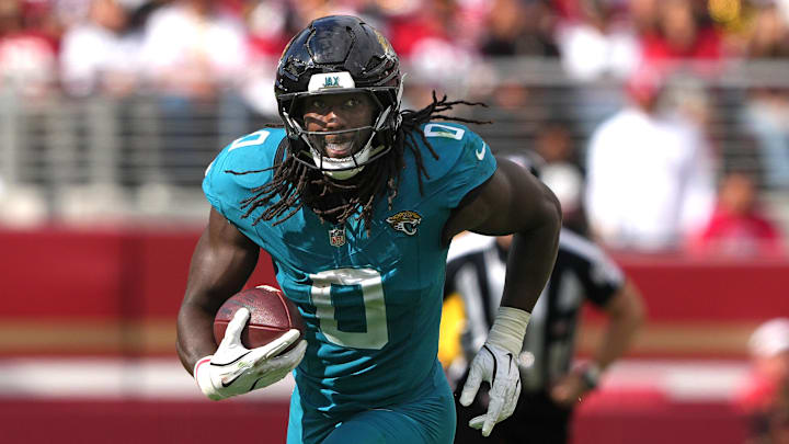 Sep 28, 2025; Santa Clara, California, USA; Jacksonville Jaguars linebacker Devin Lloyd (0) returns an interception against the San Francisco 49ers during the third quarter at Levi's Stadium. Mandatory Credit: Darren Yamashita-Imagn Images