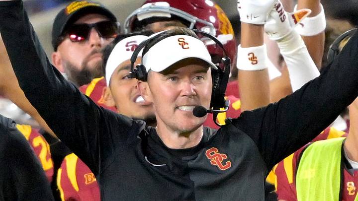USC Trojans head coach Lincoln Riley and defensive line coach Shaun Nua celebrate on the sideline. USC Trojans head coach Lincoln Riley and defensive line coach Shaun Nua celebrate on the sideline.