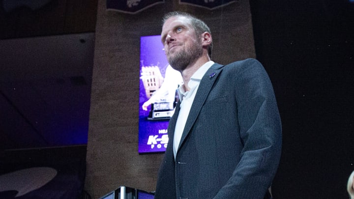 Kansas State coach Collin Klein walks through an entrance at Morgan Family Arena as he's introduced in front of a crown on Dec. 5, 2025.